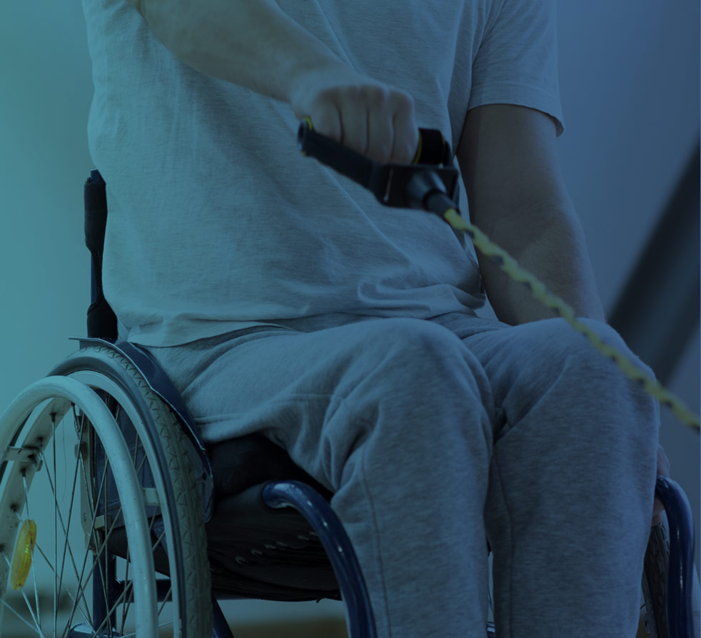 Therapist guiding a seated patient through an exercise